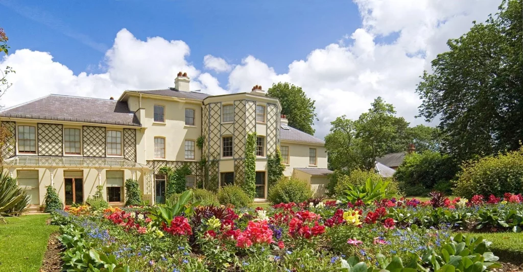 grand white house viewed across garden