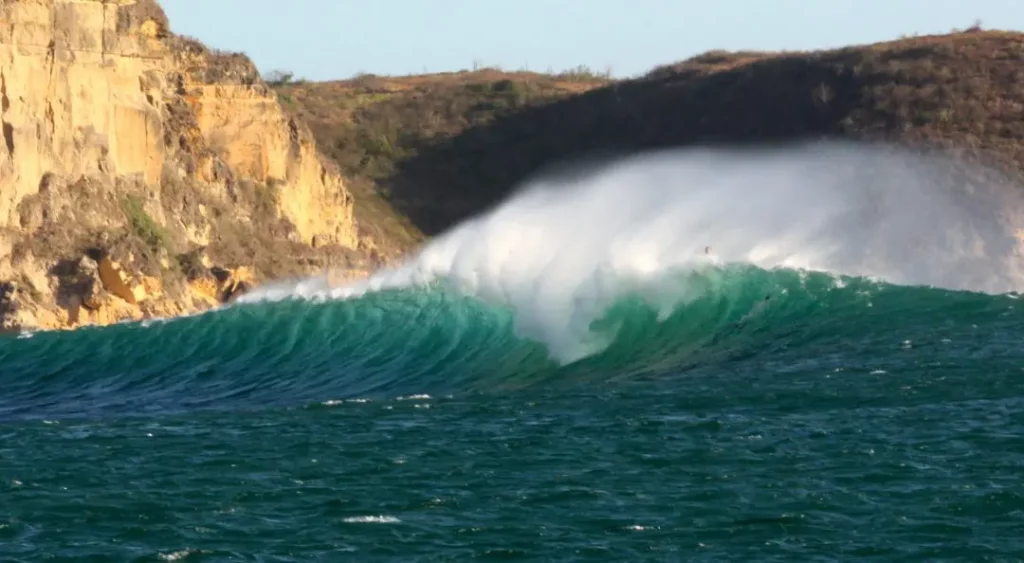 photo of surf crashing against rocks