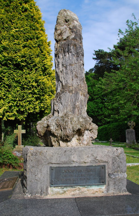 grave decorated with very phallic fossil tree trunk